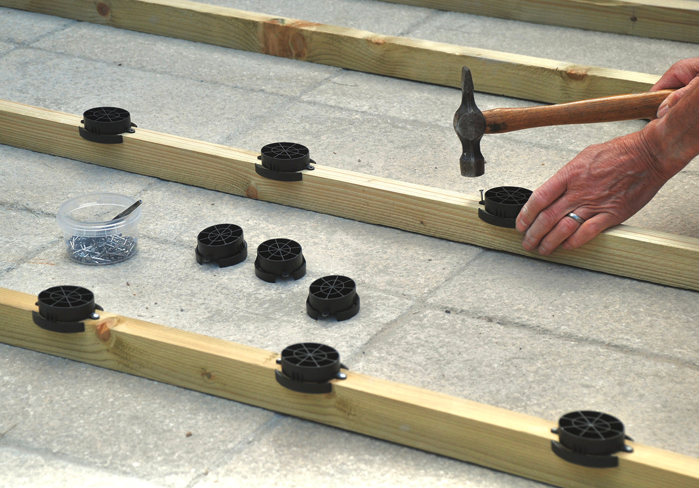 Adding plastic shed base kit to the timber base frame of a shed