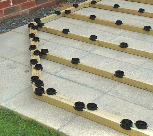 Adding a plastic shed base kit to the timber frame of a shed. The SHED BOOT elevates the bearers, keeping the floor and walls dry.